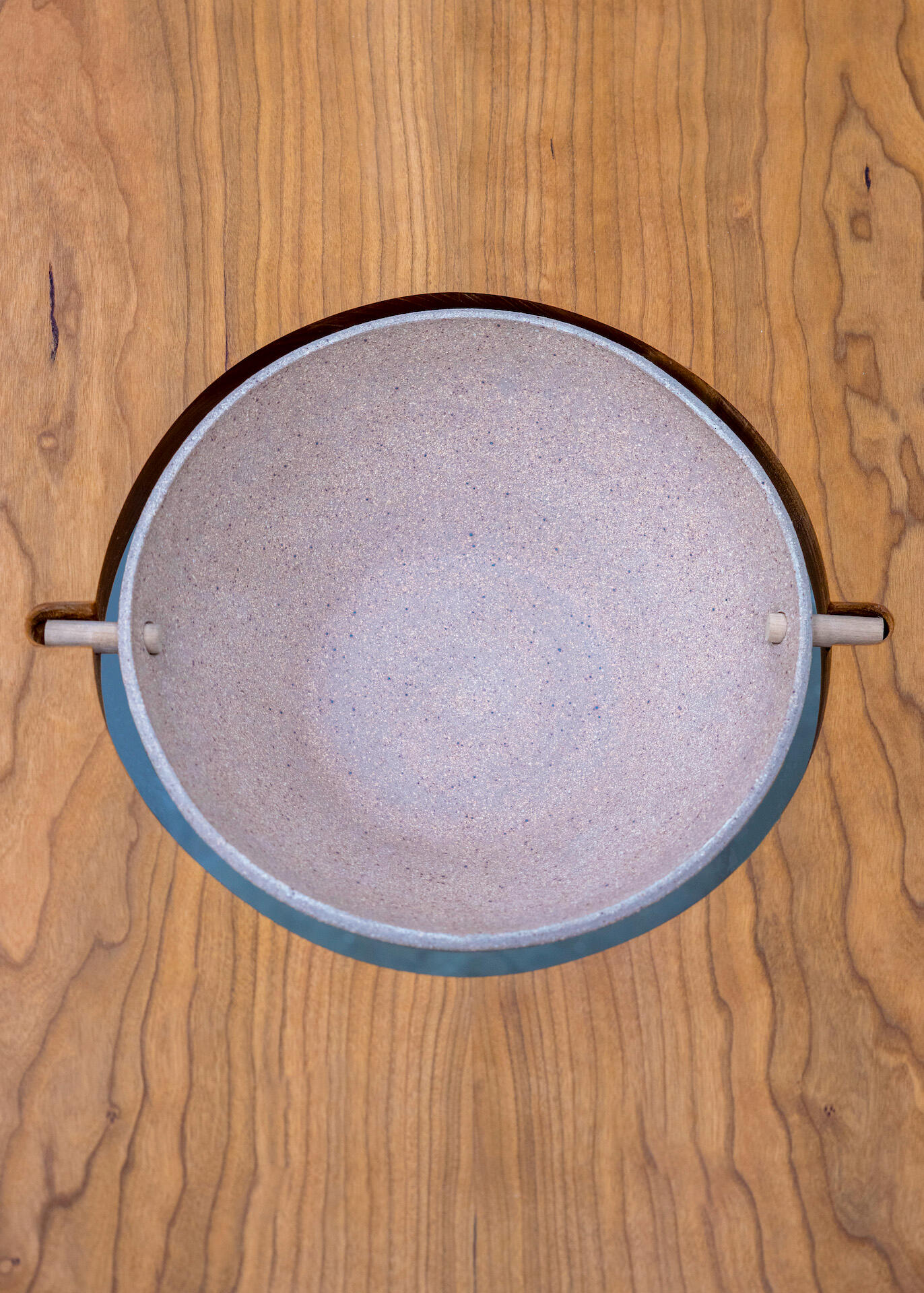 This is a detail shot of a bowl in the center of a wooden table built by Mia Donalson.